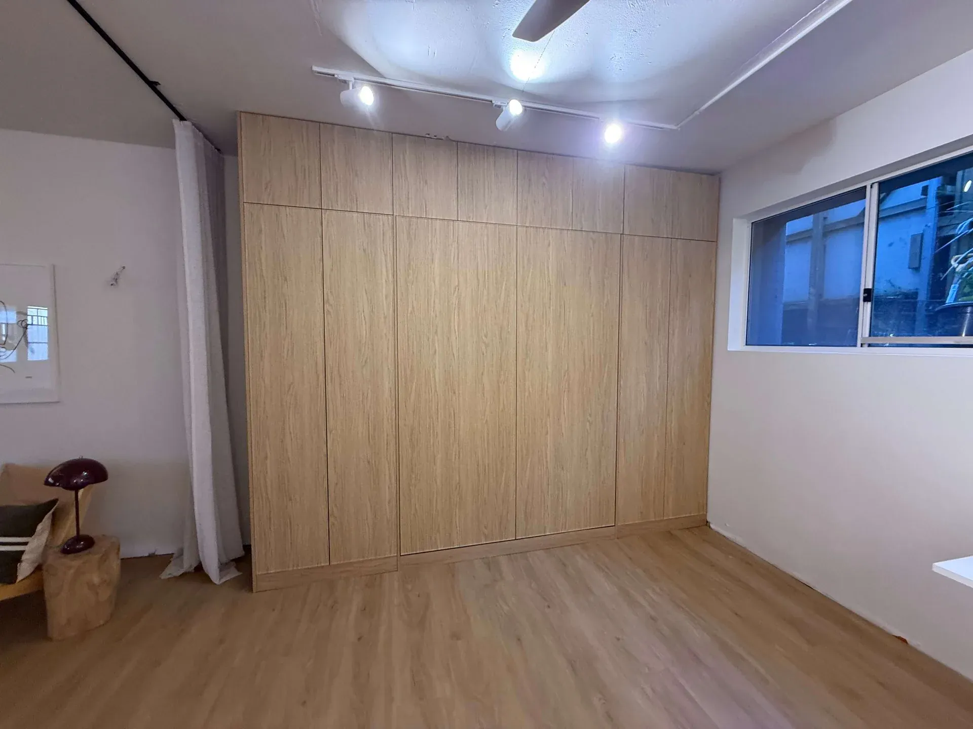 Darlinghurst Murphy bed closed — full-height Boston Oak joinery wall