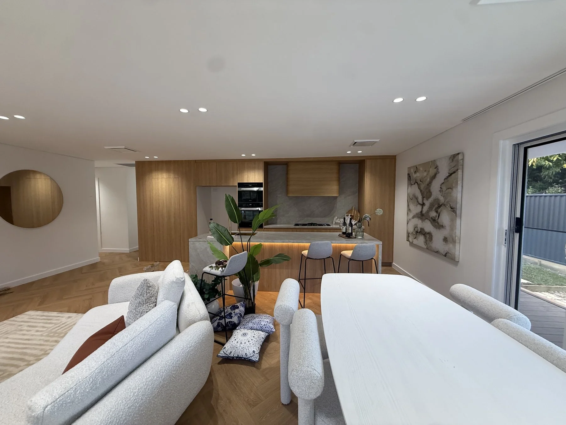Epping open-plan kitchen and dining zone with herringbone floor and full-width glazing