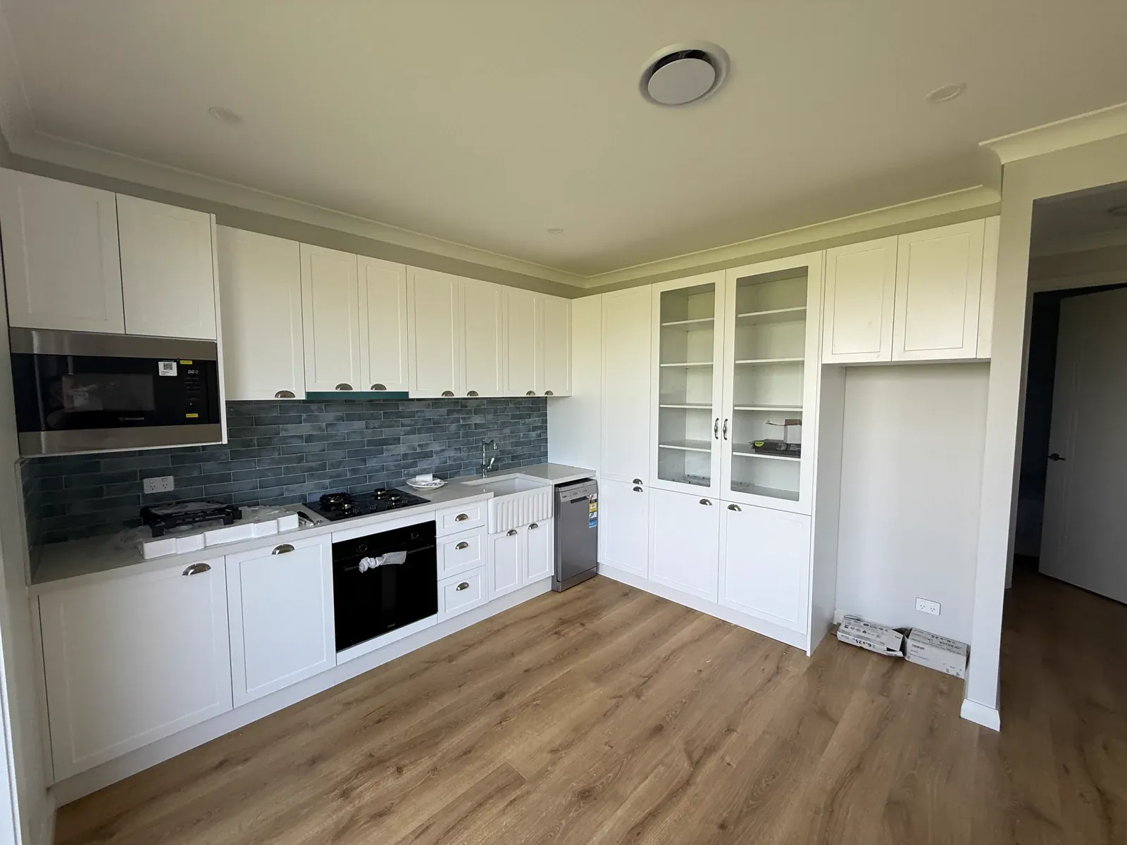 Kiama downstairs kitchen — second angle showing island and full cabinetry run