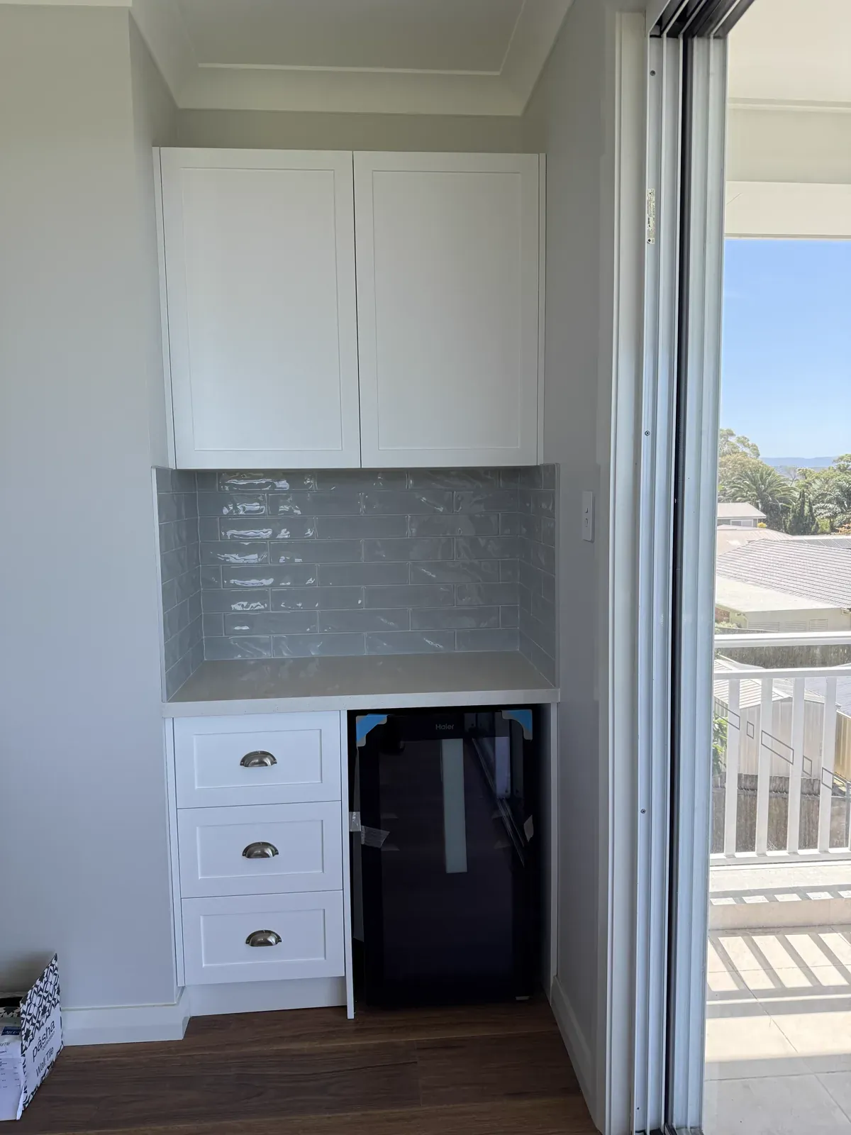 Kiama servery area — Dulux Vivid White shaker joinery in Hamptons renovation