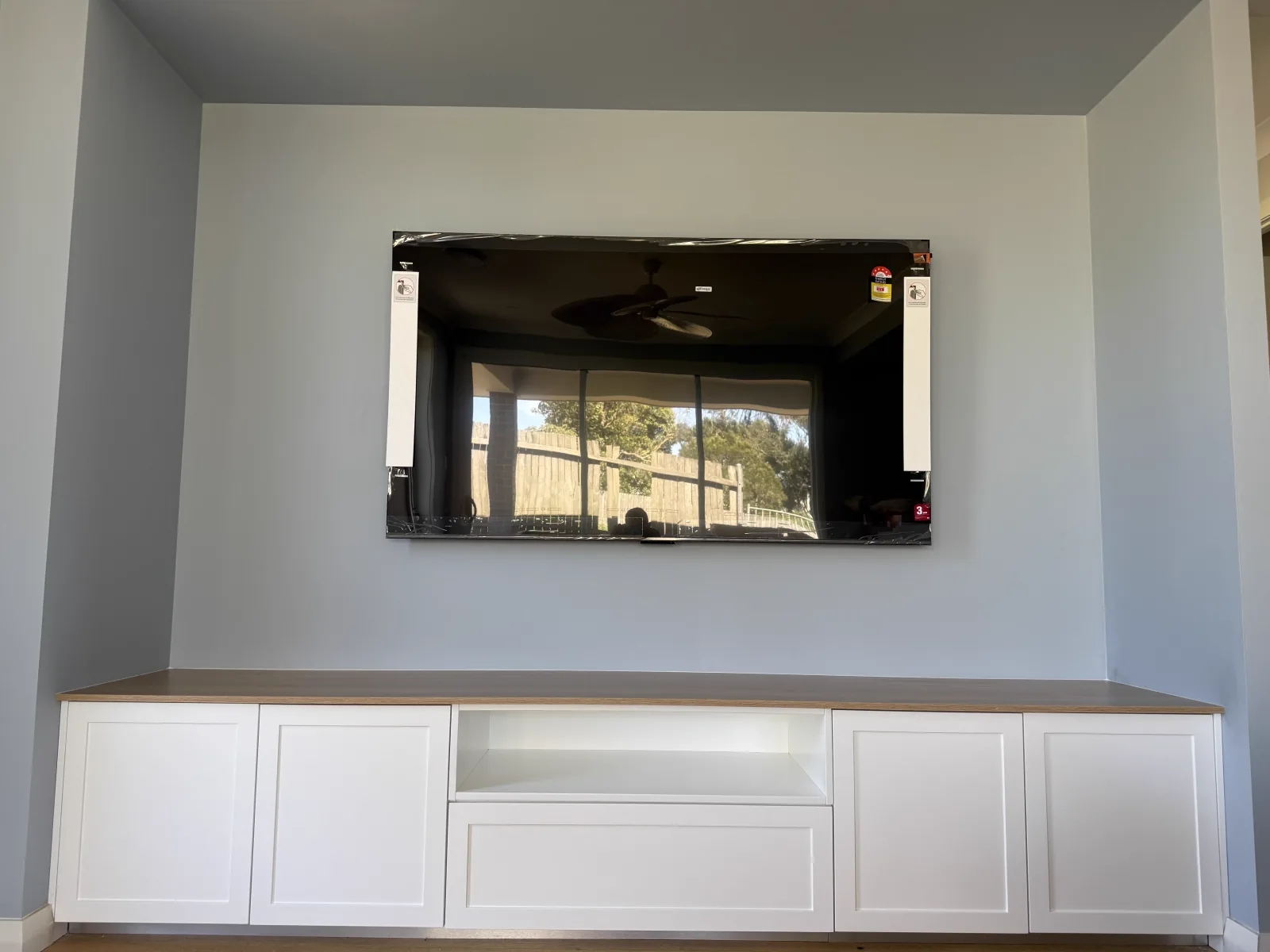 Kiama custom TV unit in Dulux Vivid White — Hamptons joinery renovation