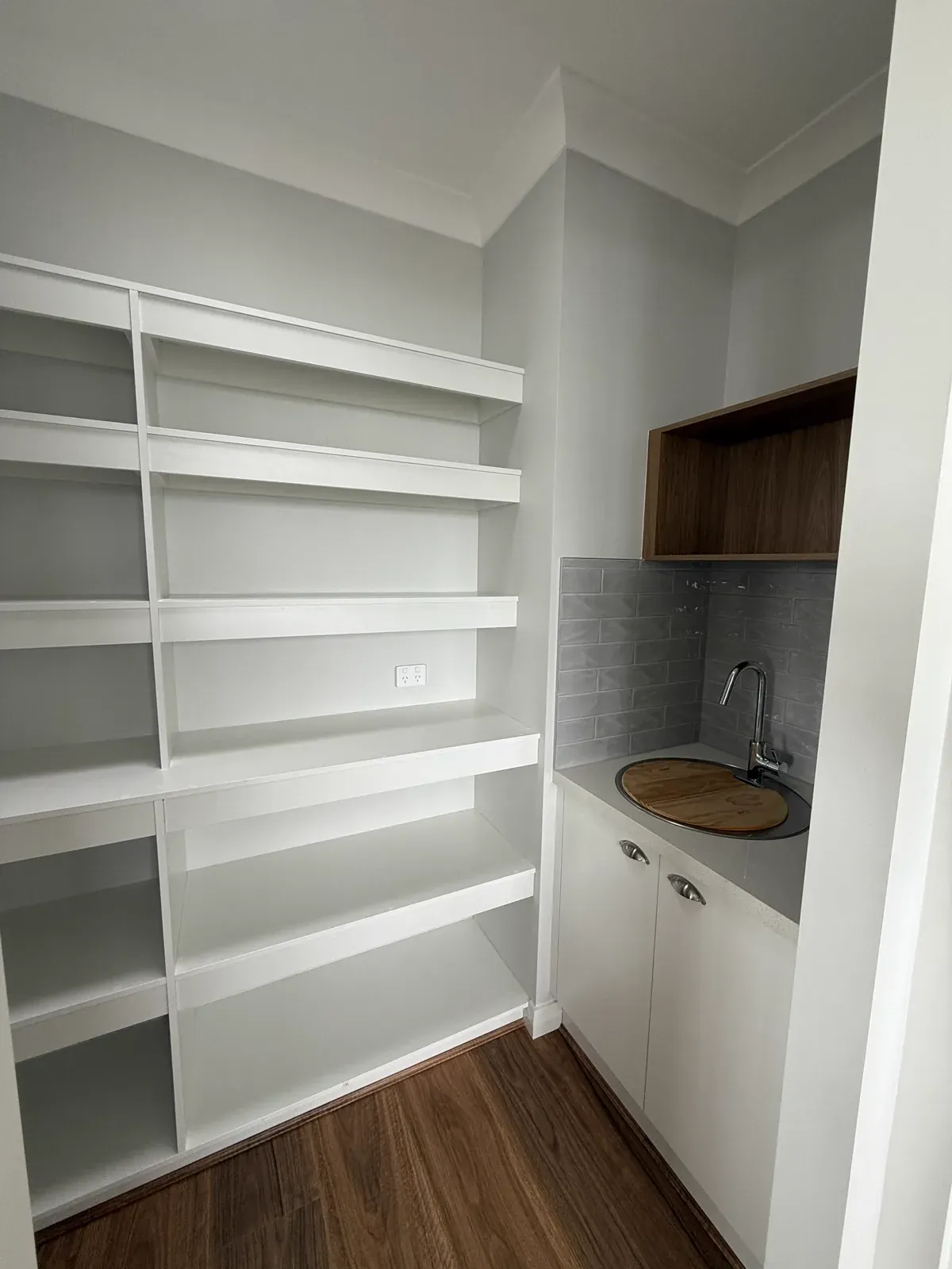Kiama butler's kitchen — Dulux Vivid White shaker with Caesarstone Osprey benchtop