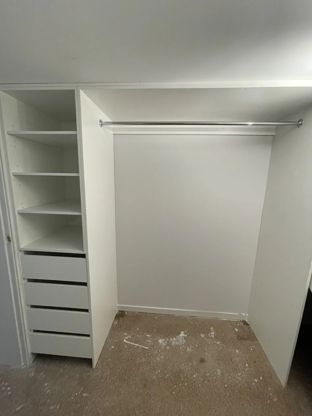 Walk-in robe with white open shelving, drawer bank and hanging rail in Leichhardt
