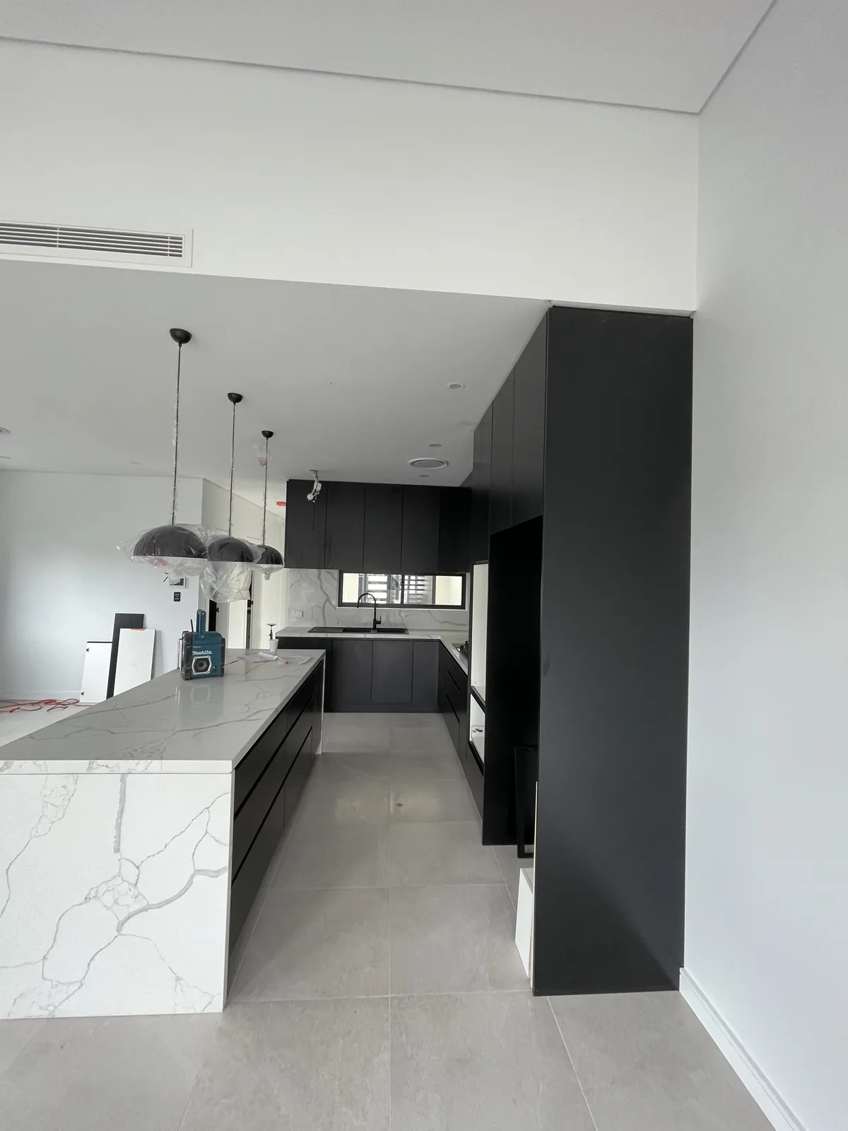 Leichhardt kitchen island and pendant lighting seen from the living area