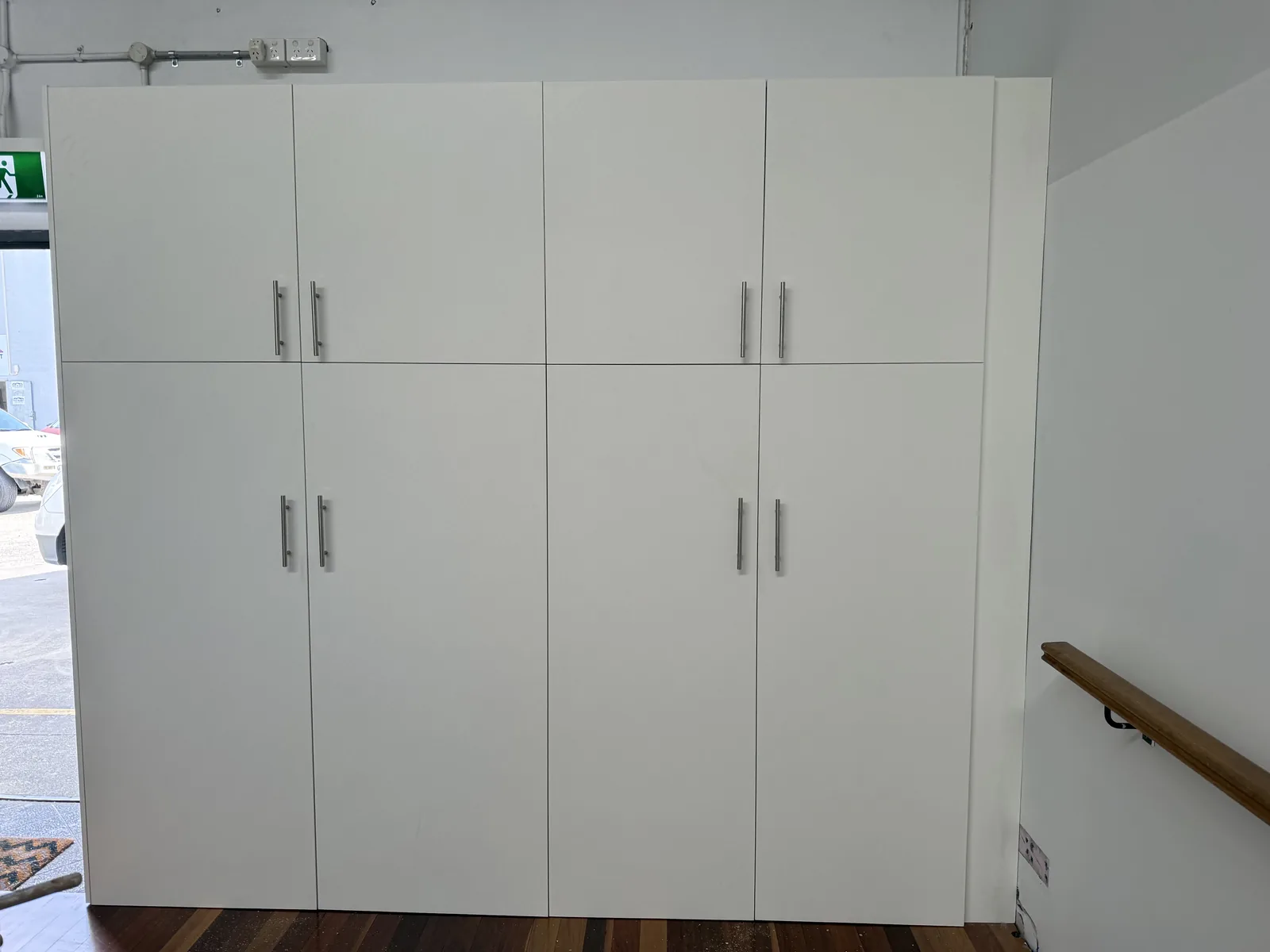 Full-height white office joinery concealing a sewing workstation in a Mascot dance studio