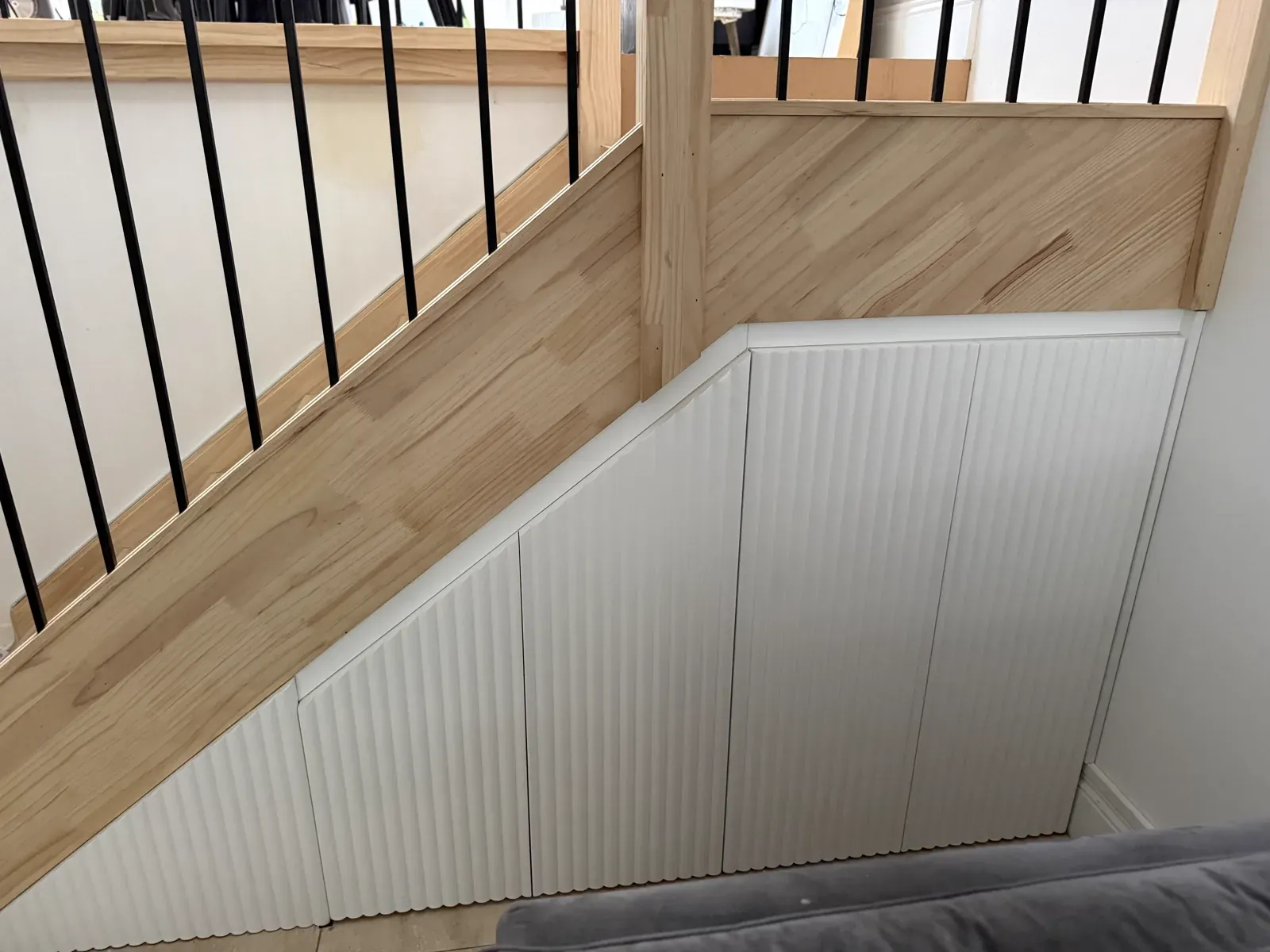 Neutral Bay understairs storage — full run of fluted panel cabinetry