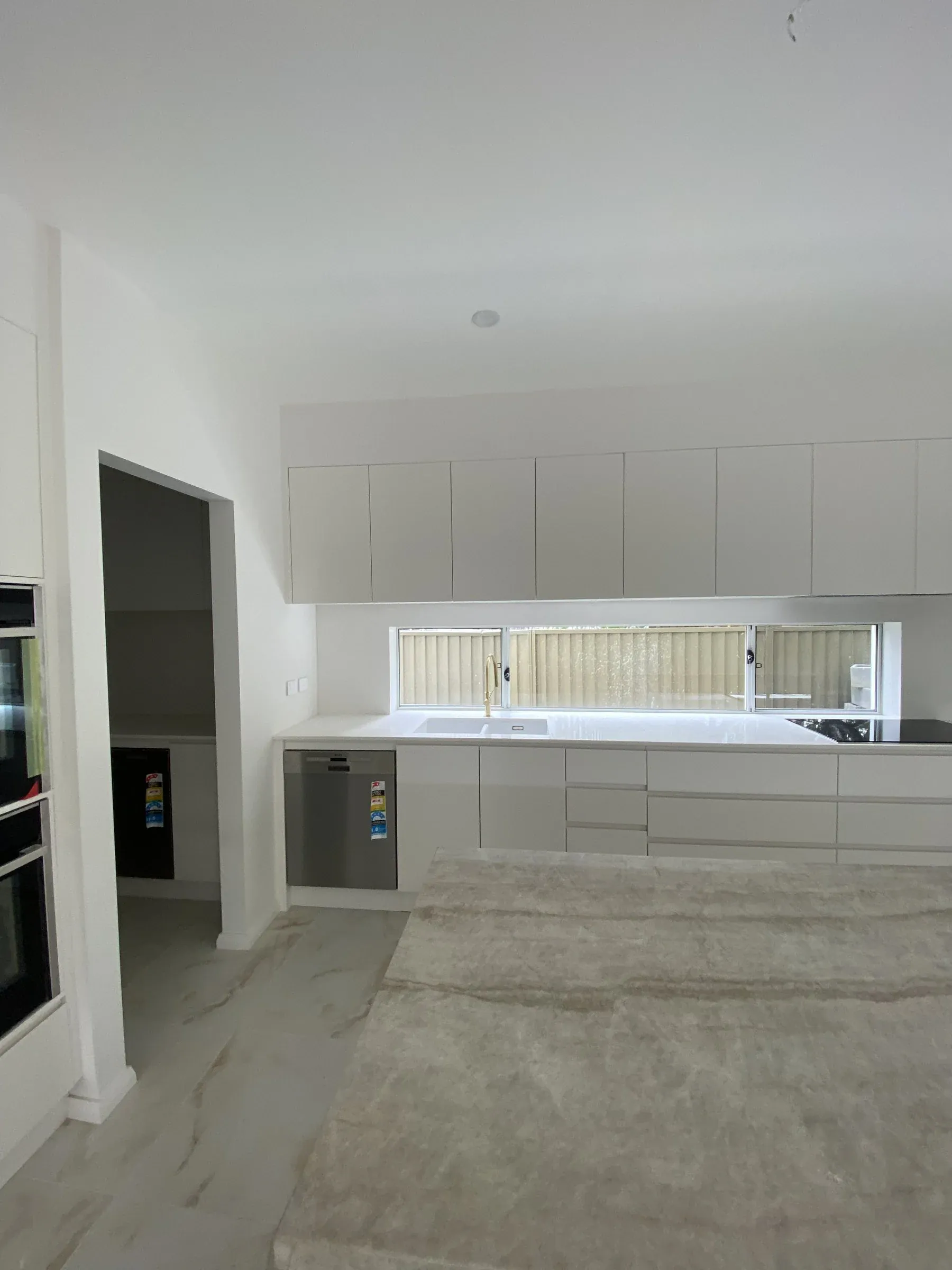 Monterey kitchen sink side with dishwasher, drawers and window splashback