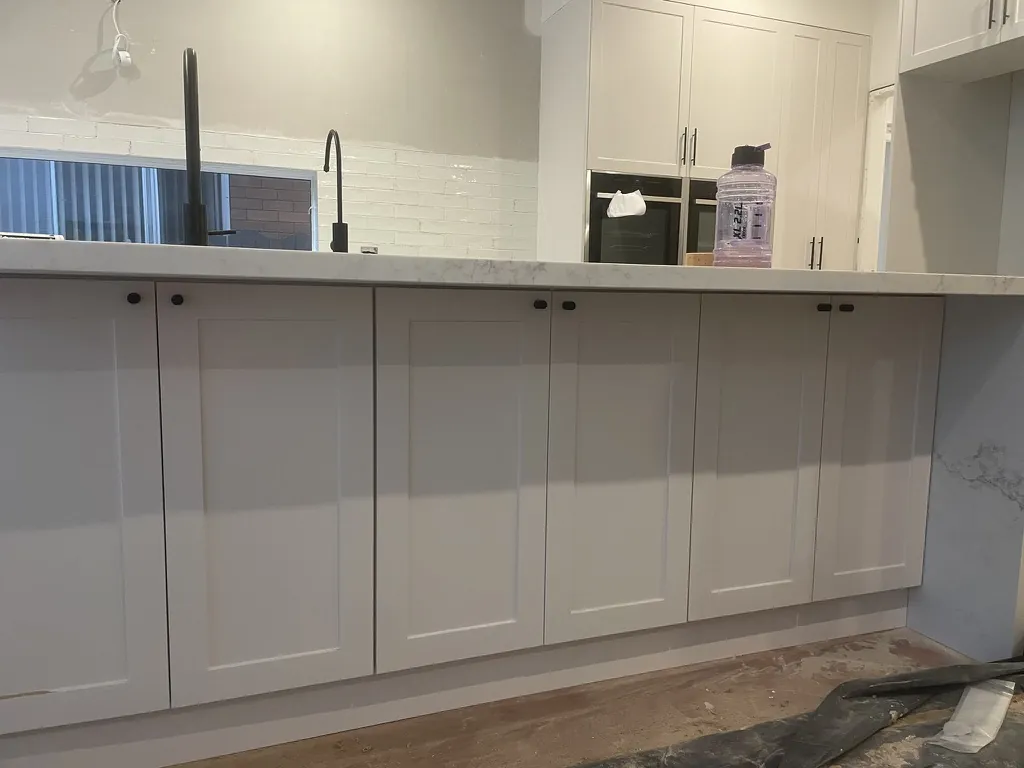 Island detail — hidden storage cabinets below the bench and stool sitting area