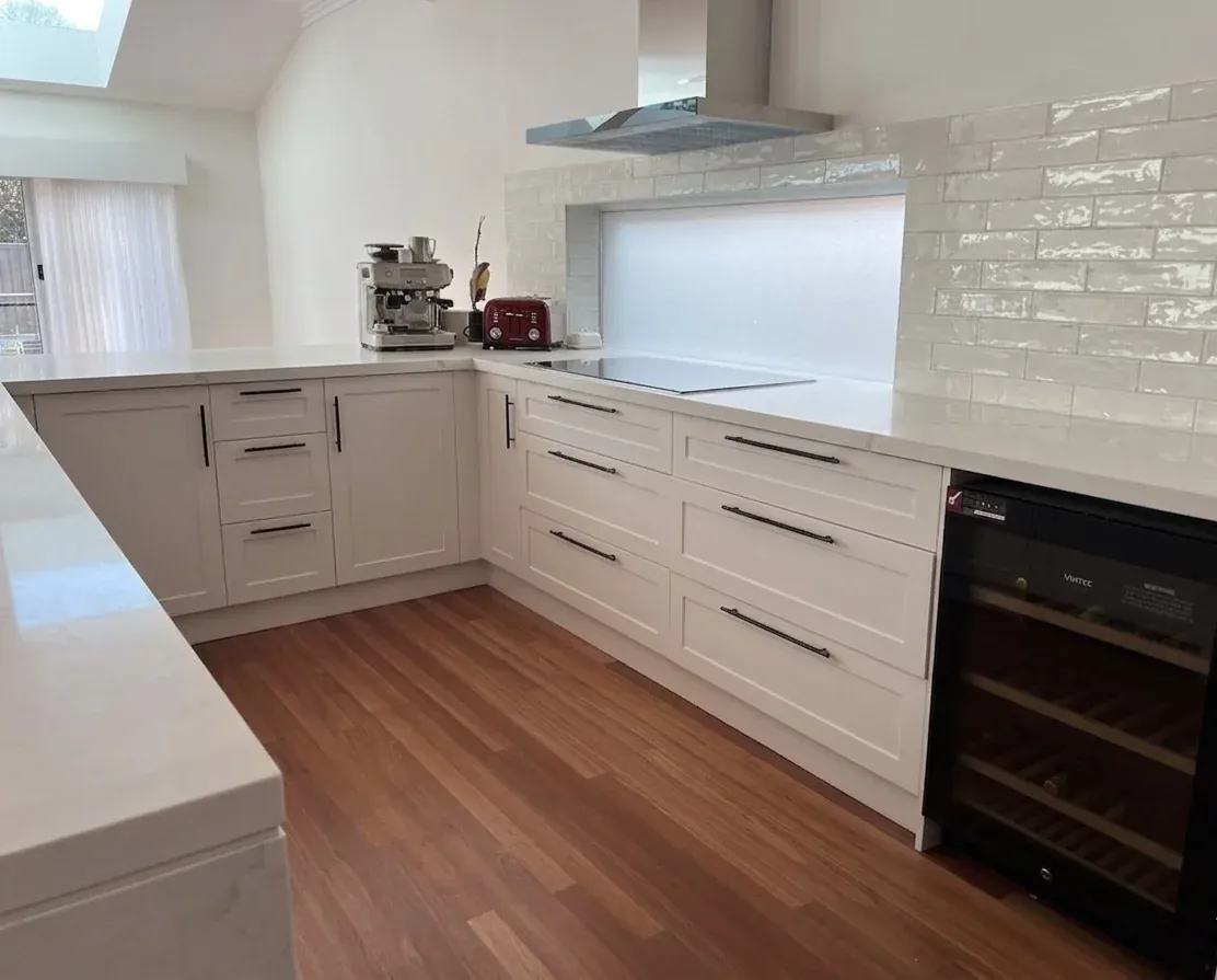 U-shape kitchen side run — shaker drawers, induction cooktop, tile splashback, wine fridge