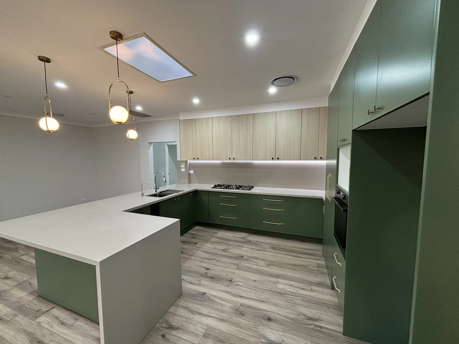 Stanhope Gardens kitchen showing the full-height green cabinetry, wall oven and skylight
