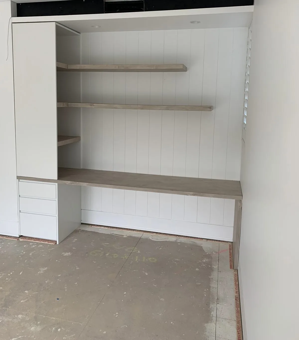 Polytec Angora Oak wall lining with floating shelves in a Waverley study