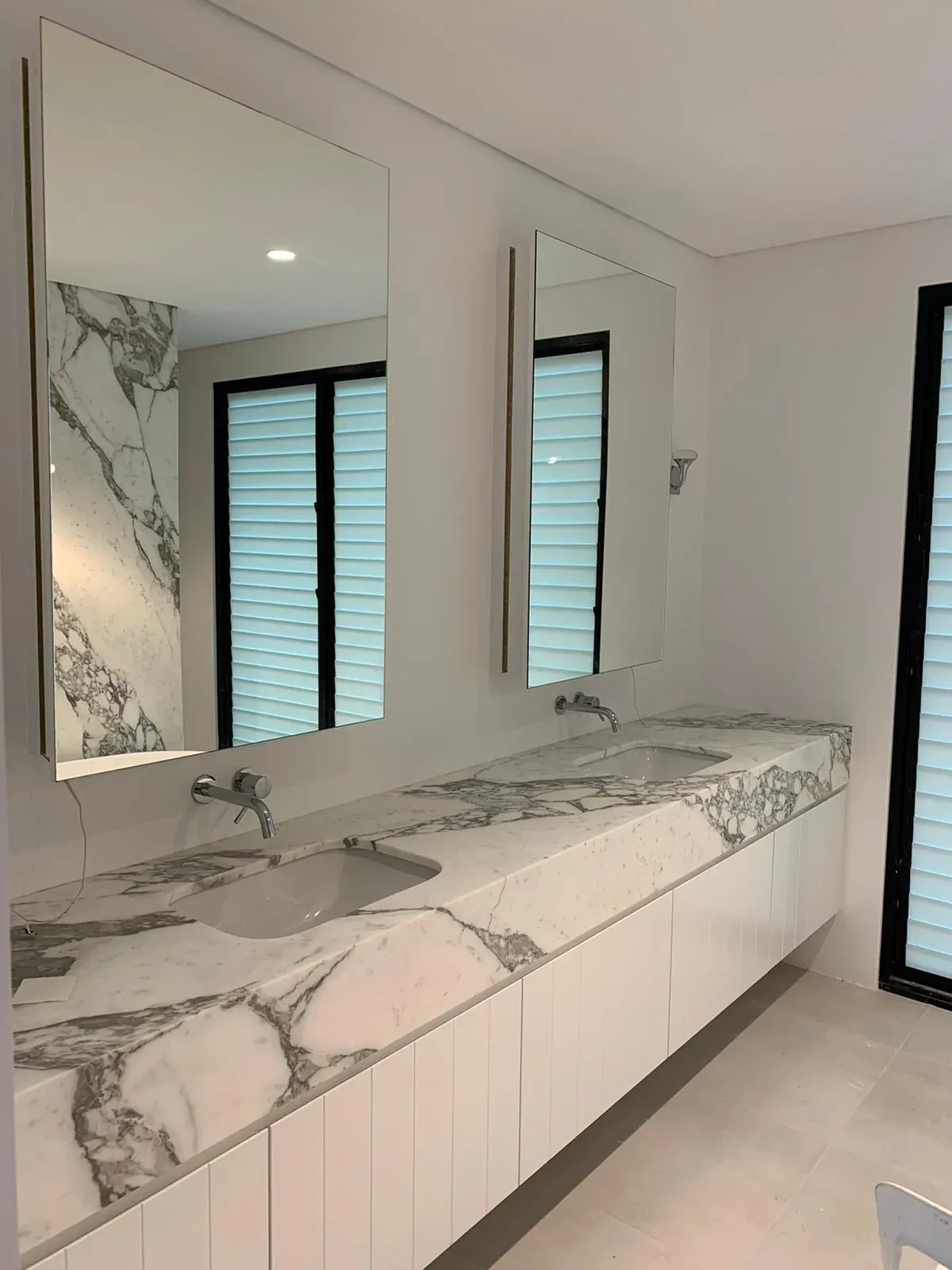 Double vanity side angle showing the stone waterfall end in Waverley