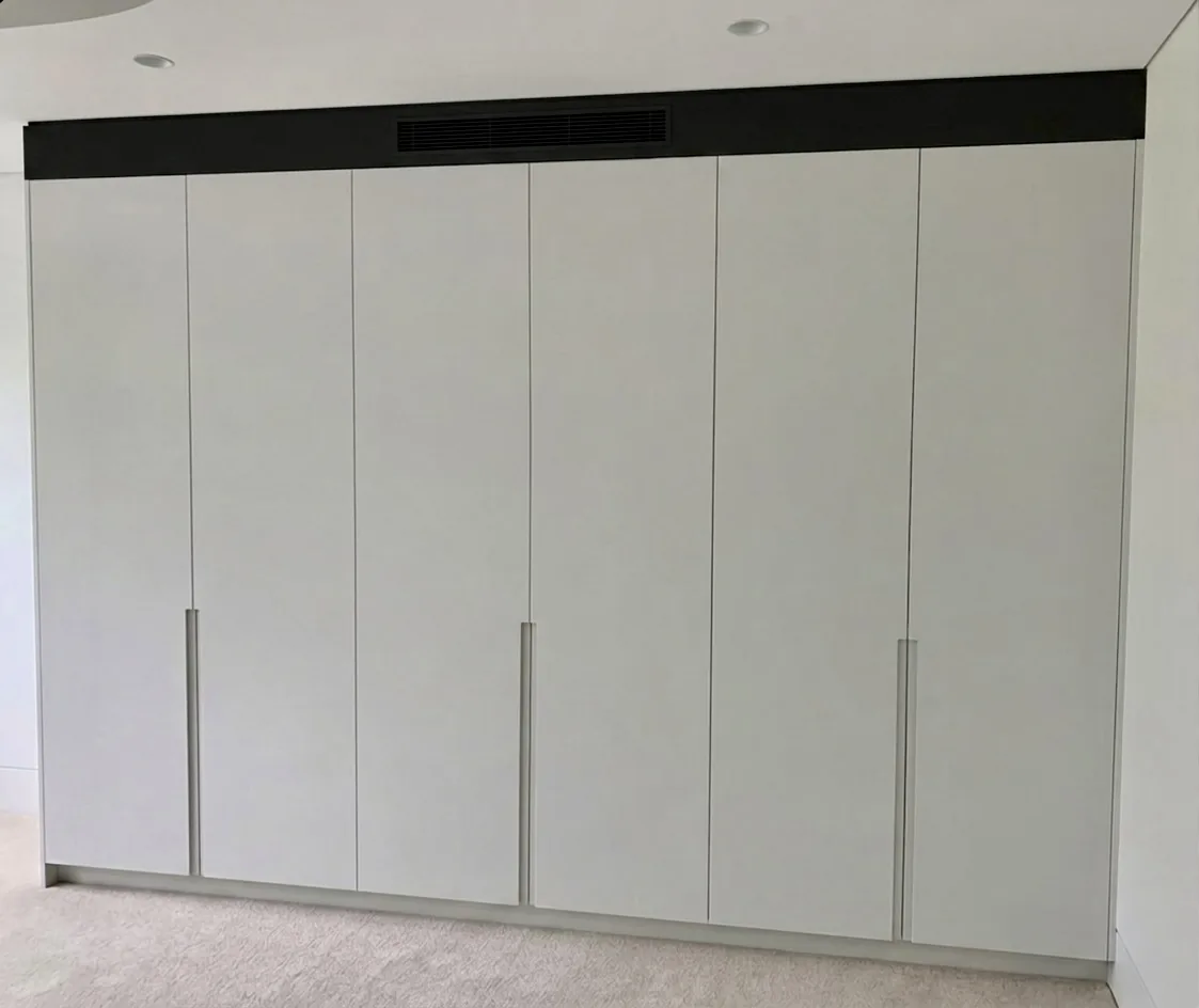 White polyurethane flat board wardrobe doors with J-pull in a Waverley bedroom