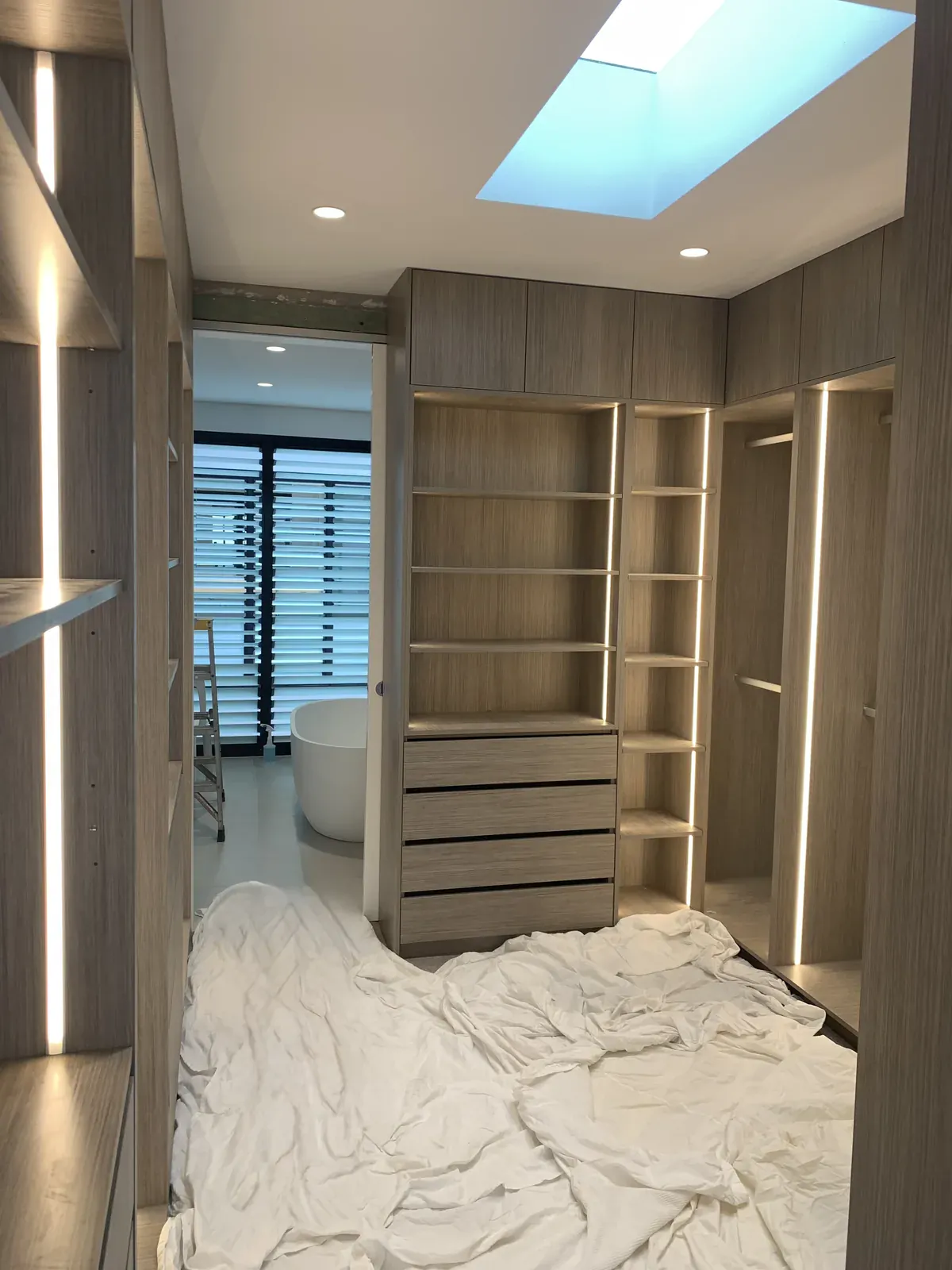 Manor Oak Woodmatt walk-in robe with push-to-open overhead storage in Waverley