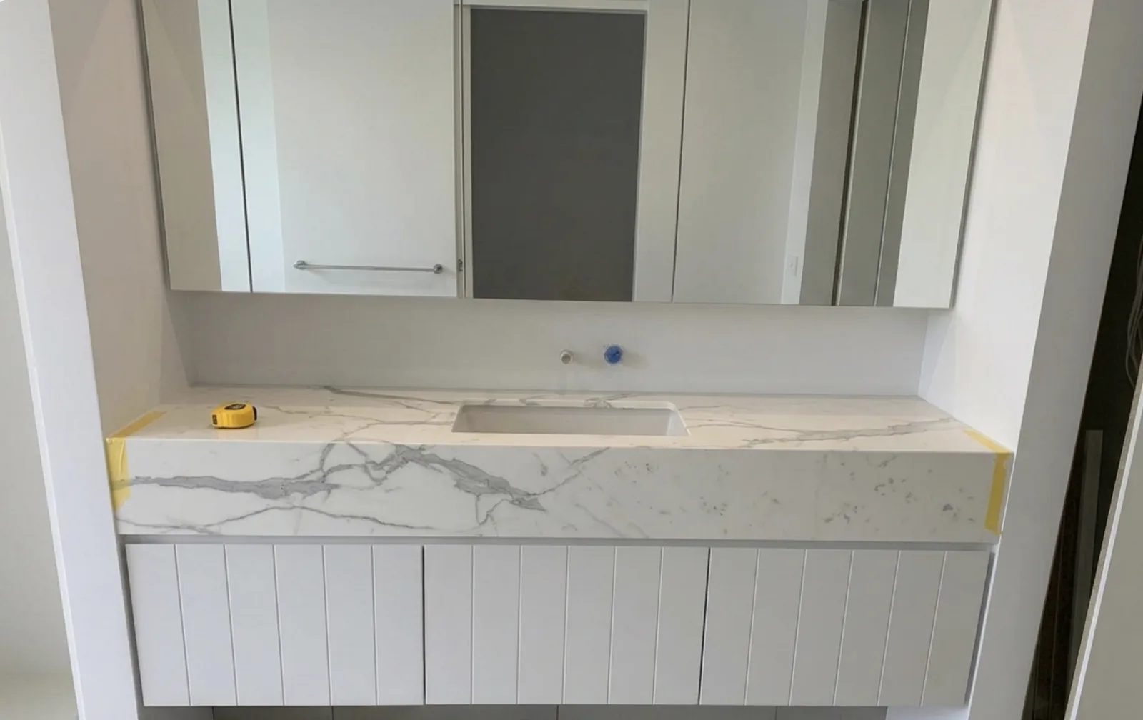 Walkway vanity with V-groove wall lining in a Waverley home