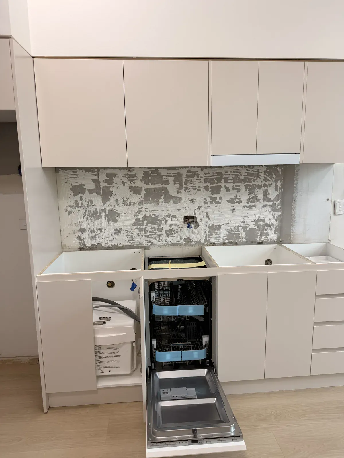 Kitchen cabinetry installed with the integrated dishwasher panel open in Willoughby