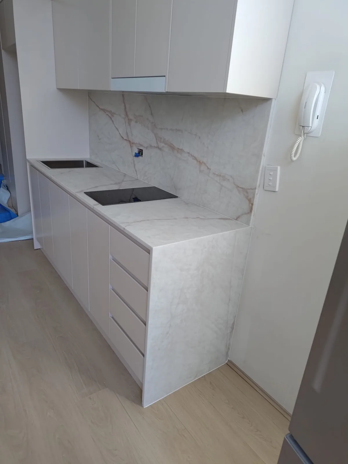 Stone benchtop return in a Willoughby apartment kitchen