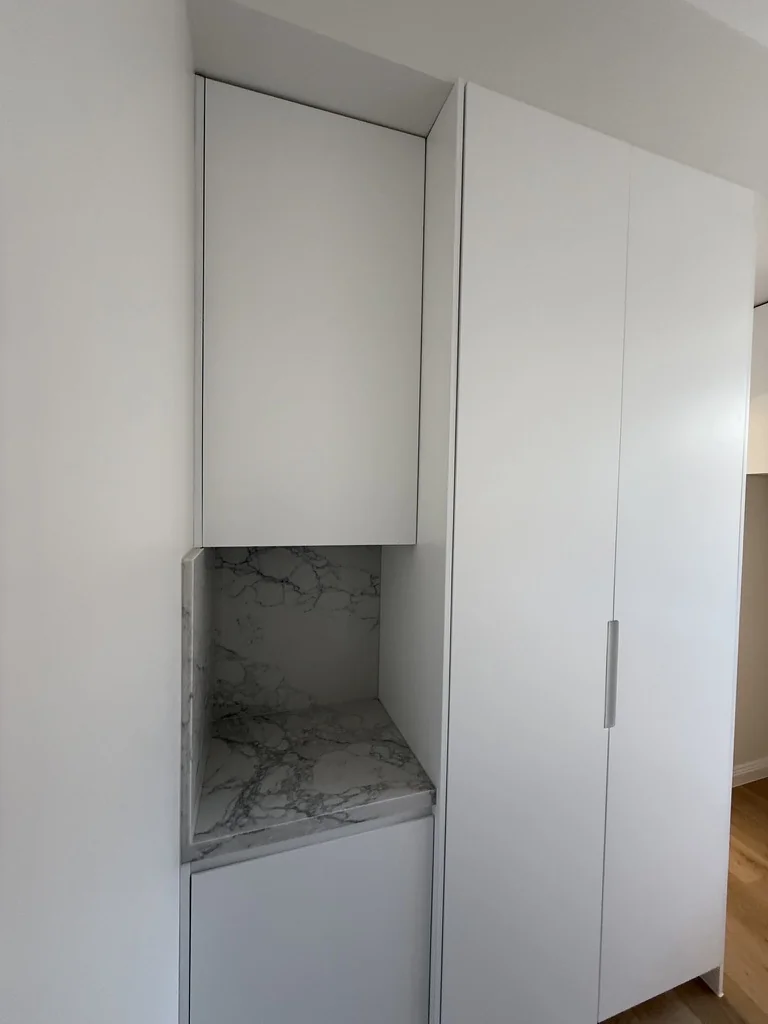 Willoughby laundry L-shape layout — sink, marble benchtop and tall pantry column
