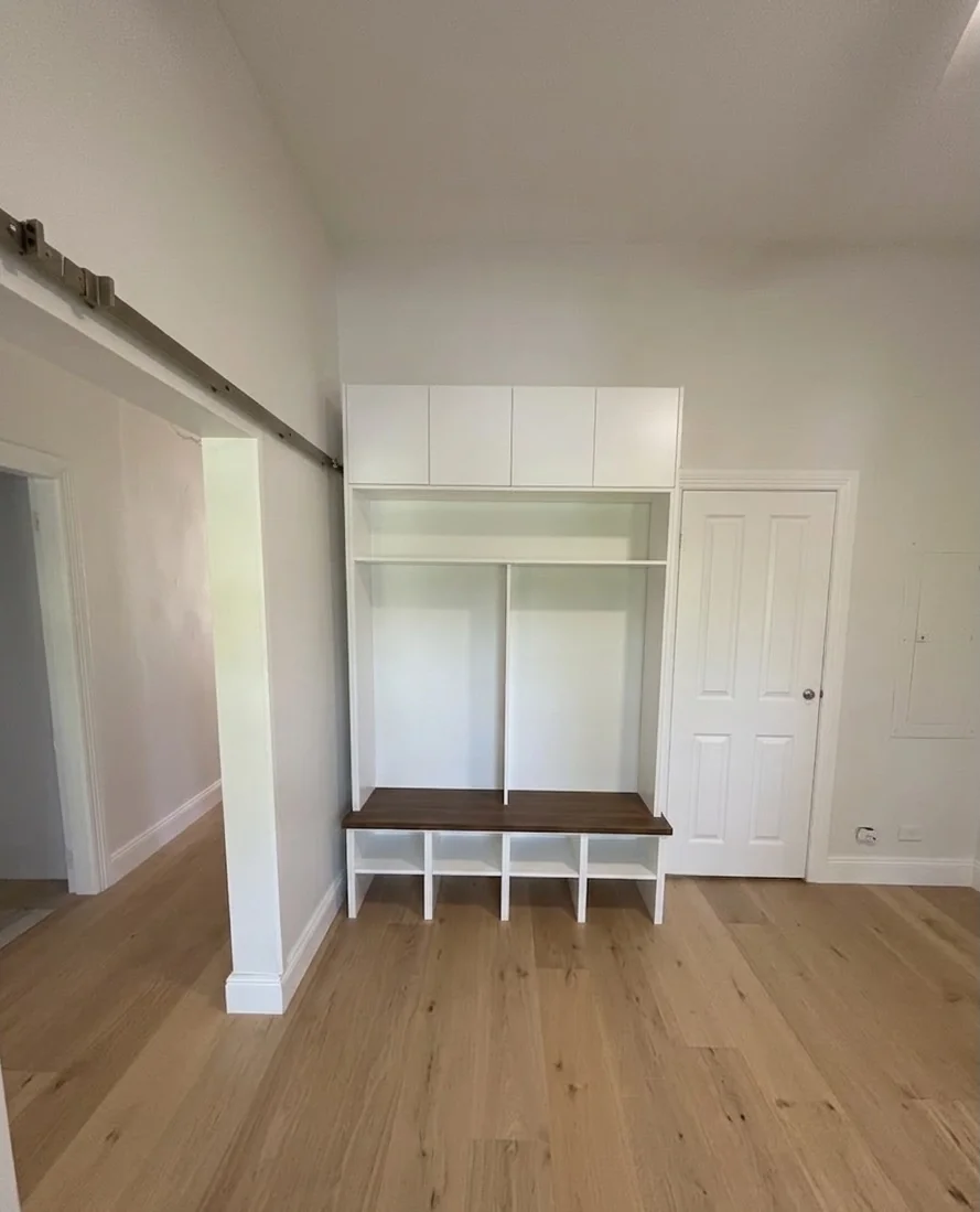 Willoughby mudroom hallway joinery — white built-in storage with sliding door